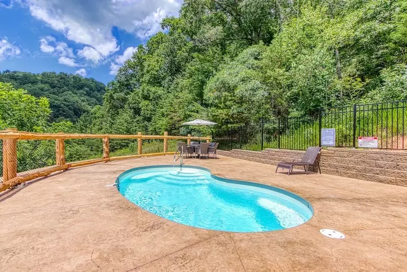 swimming pool outside of large cabin rental