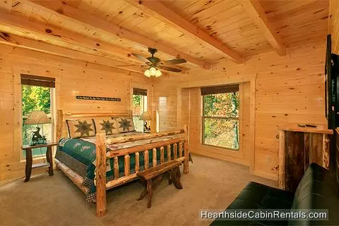 A View for All Seasons cabin near Gatlinburg king bed with wooded view