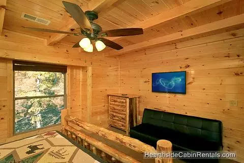 A View for All Seasons cabin near Gatlinburg king bedroom with full-size futon couch and tv