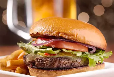 burger and fries on table at restaurant