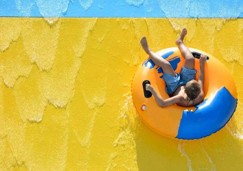 boy on a water ride in a tube