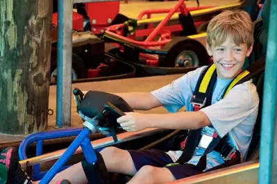 Boy sitting and smiling in a go-kart