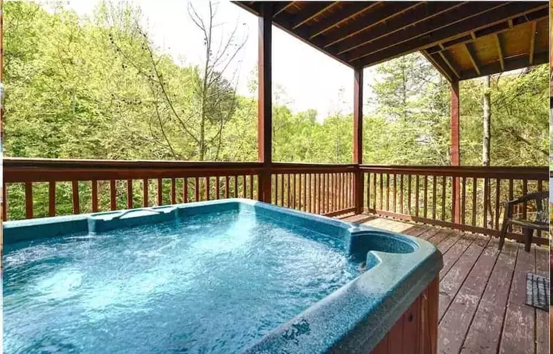 hot tub on deck of large cabin rental in smoky mountains