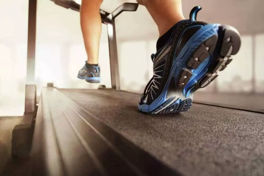 woman walking on treadmill in exercise facility