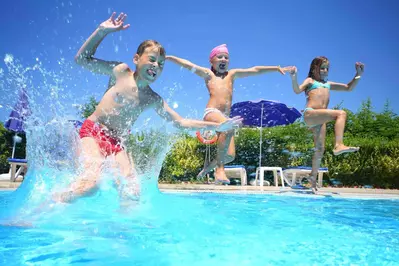 kids jumping into the pool