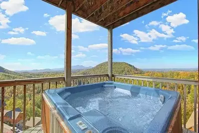 hot tub on the deck of heaven's corner, a large cabin in gatlinburg