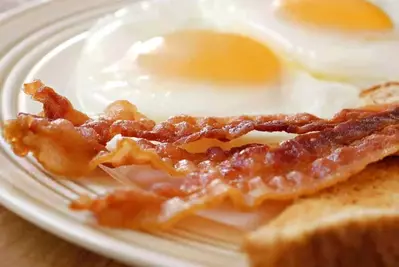 Closeup photo of bacon, eggs, and toast.