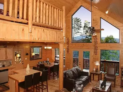 The living room of the Can't Bear to Leave cabin in the Smoky Mountains at sunset.