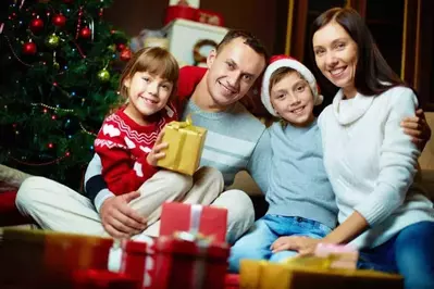 family in a smoky mountain cabin at christmas