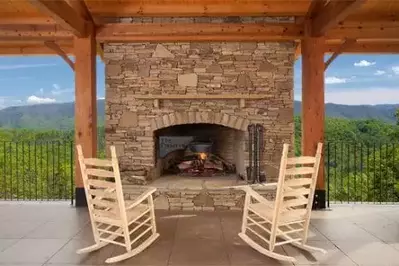 Outdoor fireplace at one of our large group cabins in Pigeon Forge TN.