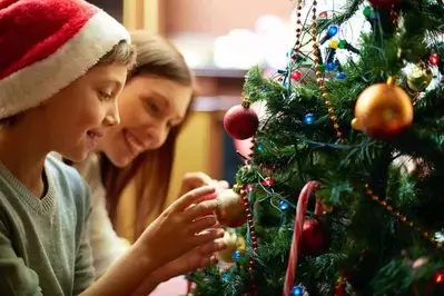 Family decorating a Christmas tree